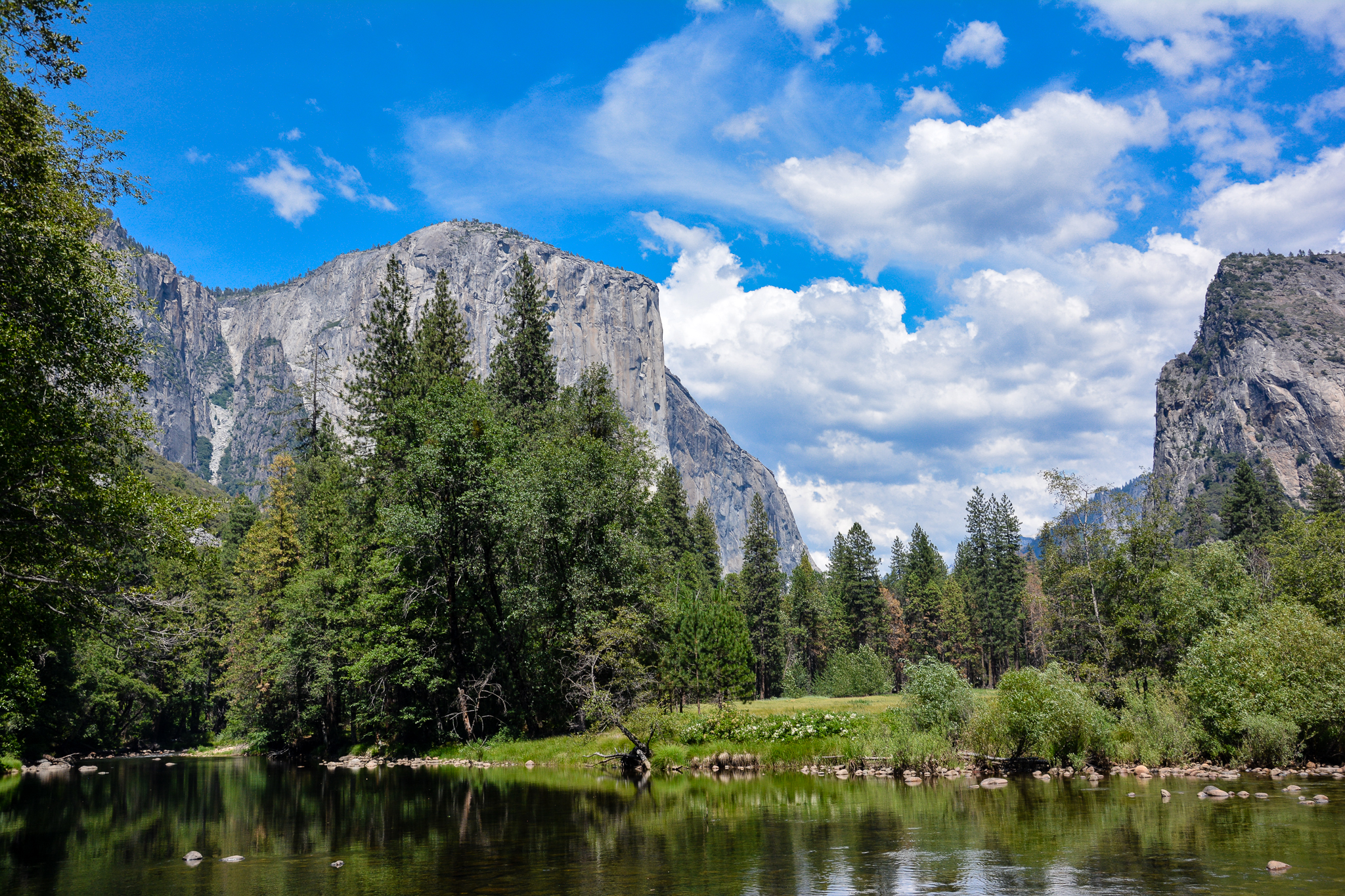 beautiful peaks of Yosemite National Park with blue skies, puffy white clouds - US National Parks by state