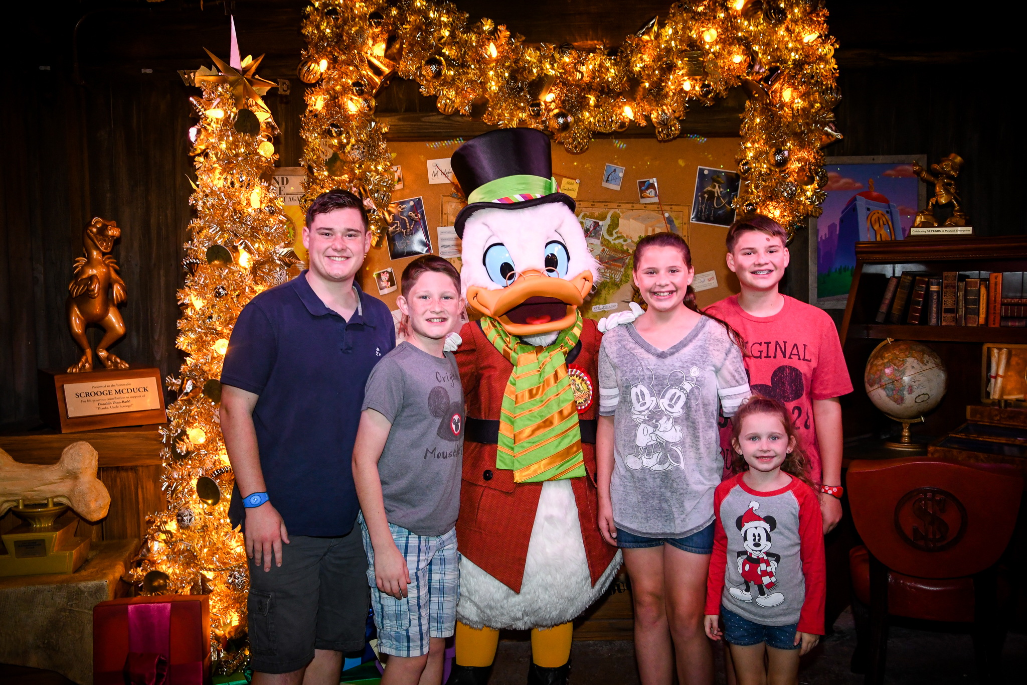 Scrooge McDuck meeting with five kids at Animal Kingdom while it's all decked out for Christmas
