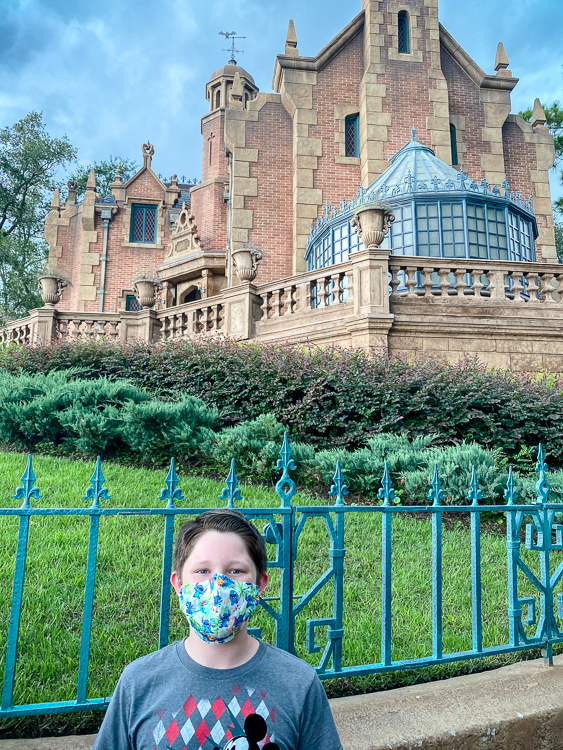 Teen boy in front of Haunted Mansion WDW