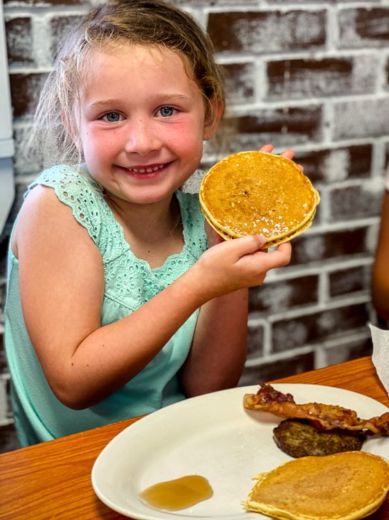 Smiling girl with pancake things to do in Carolina Beach