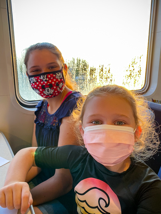 Two smiling girls wearing masks onboard the Yankee Freedom III