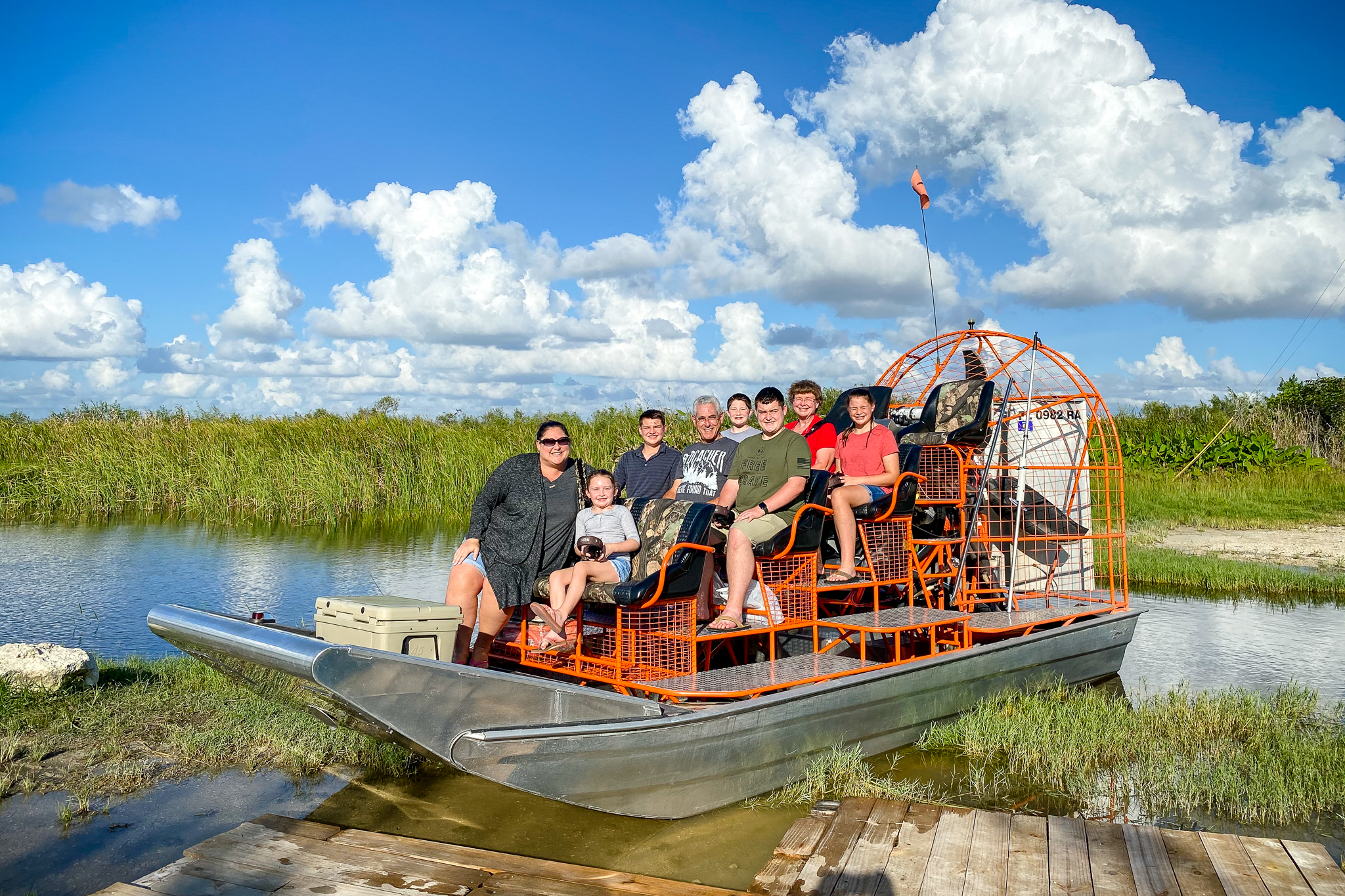 Smiling family on airboat ready to explore the Everglades