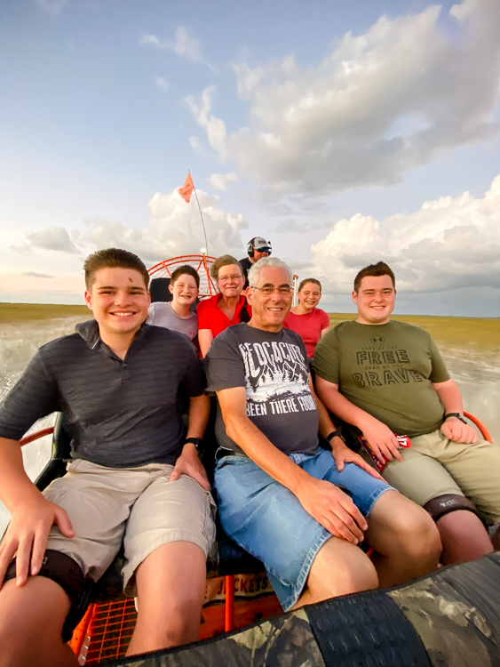 Family enjoying thrilling airboat ride through the Everglades