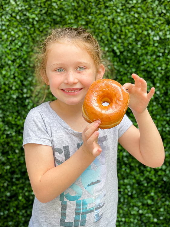 Smiling girl with glazed donut