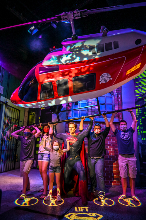 Kids helping Superman with helicopter at Madame Tussauds