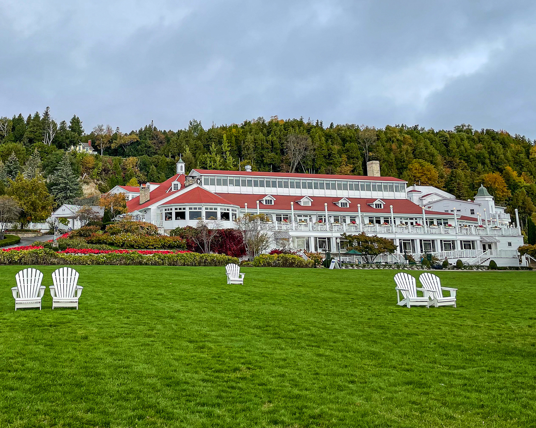 massive Great Lawn, dotted with Adirondack chairs, at Mission Point Resort Mackinac Island