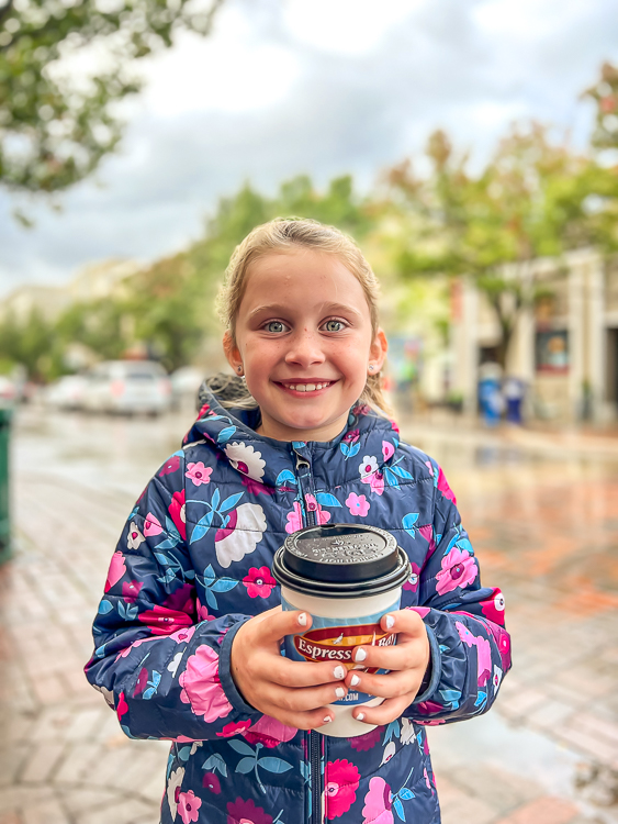 girl with Espresso Bay coffee cup best places to eat Traverse City