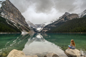 girl sitting on a rock at Lake Louise
