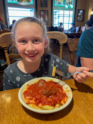 girl with penne and meatballs at Old Spaghetti Factory