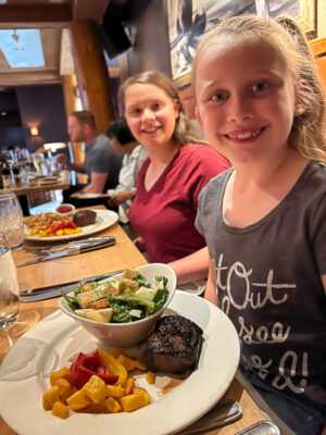smiling girls at The Keg Steakhouse in Banff