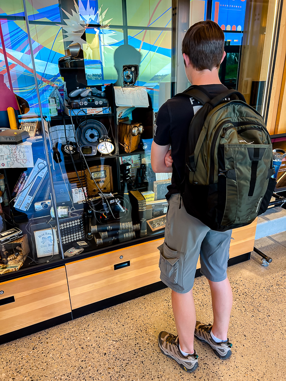 Boy with backpack looking at Storyseeker exhibit Innovations Crossing