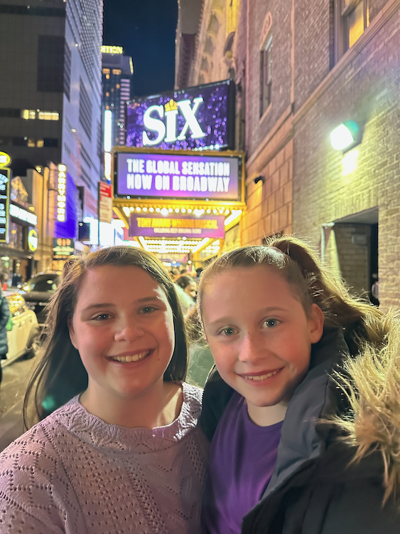 smiling girls outside six on broadway with kids